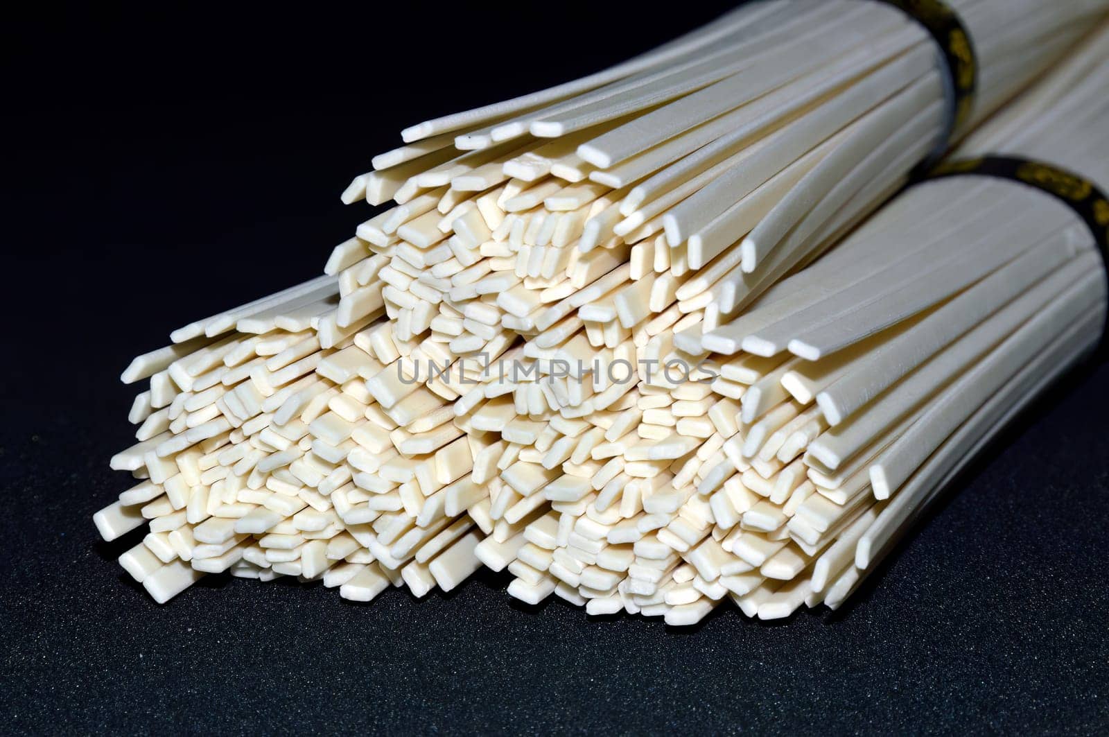 Selective focus of the udon noodles isolated on black background