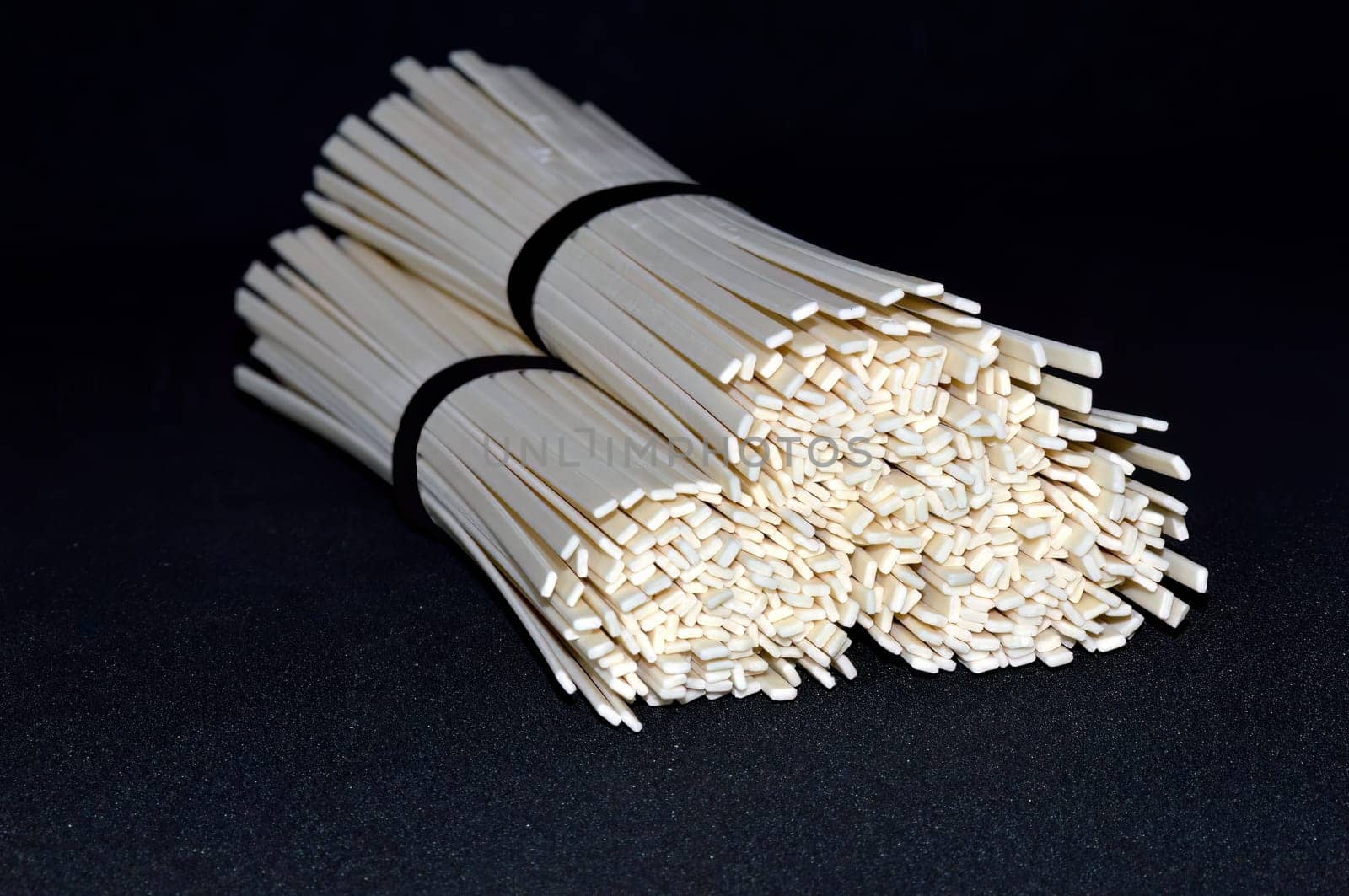 Selective focus of the udon noodles isolated on black background