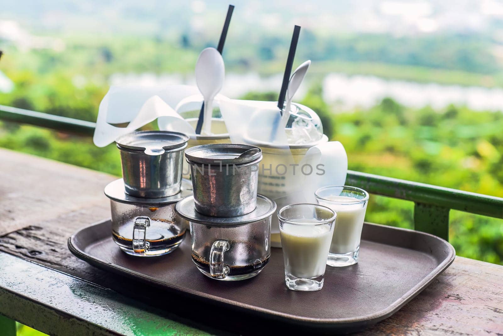 Vietnamese traditional coffee with milk on wooden table