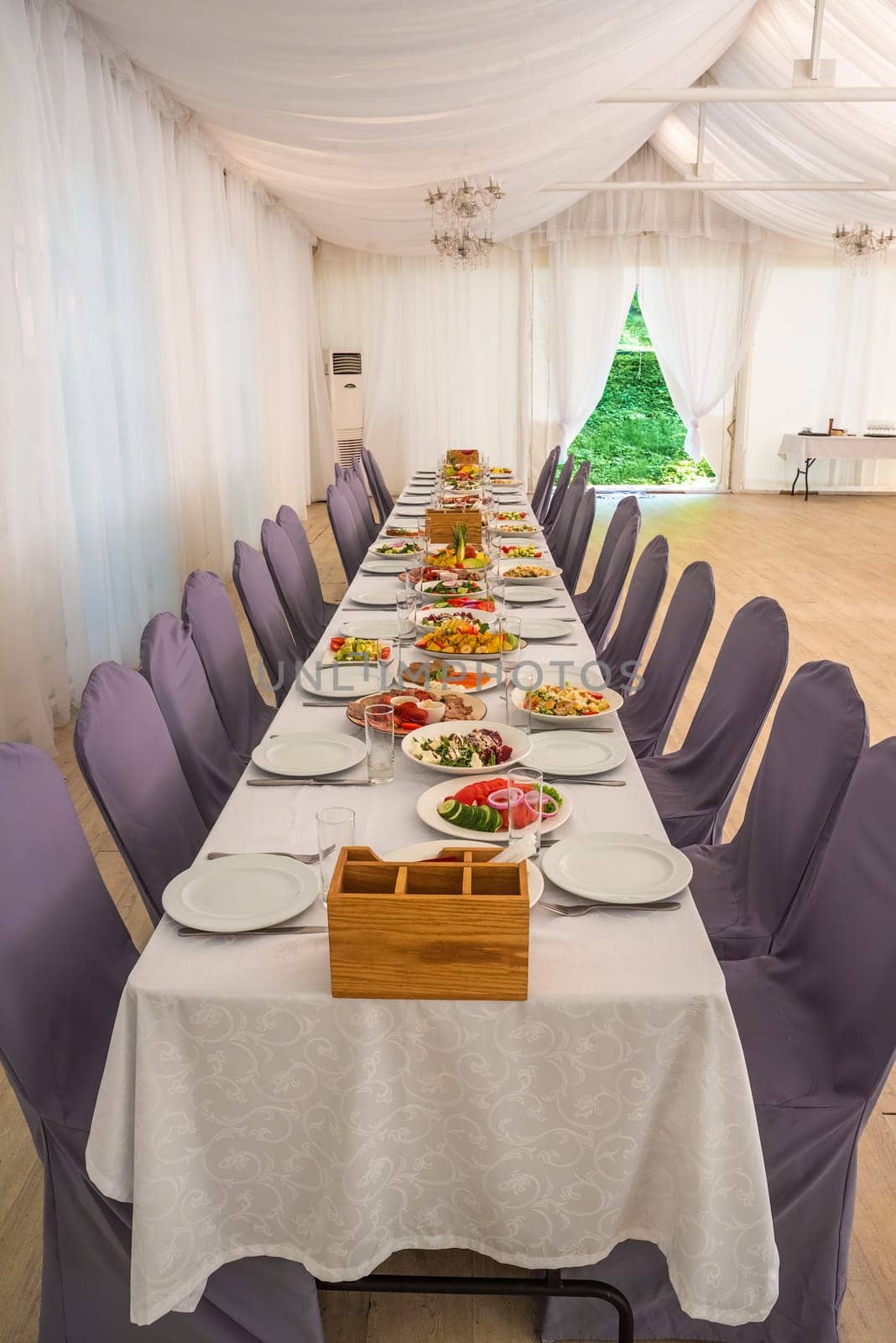 festive table set with Caesar salads, beets, fruit plate without people