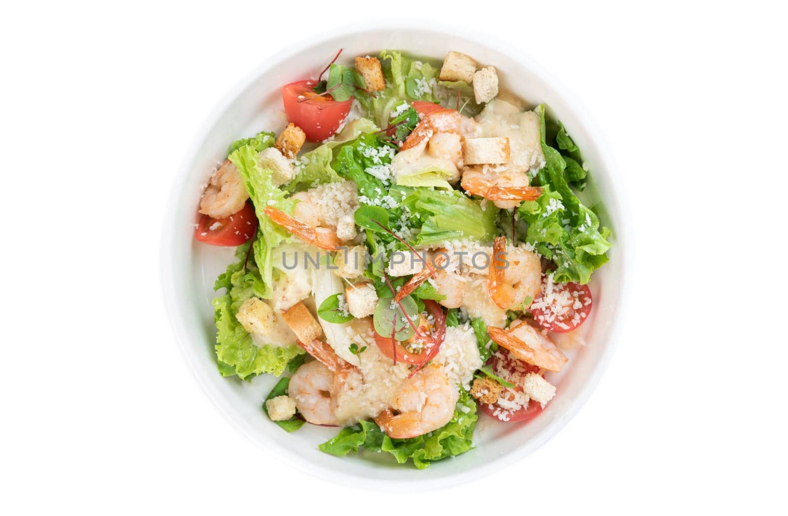 Caesar salad with shrimps on white background top view