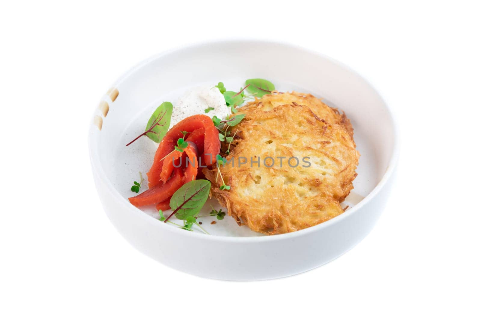 Russian and Belarus draniki or potato pancakes wish sour cream and smoked salmon
