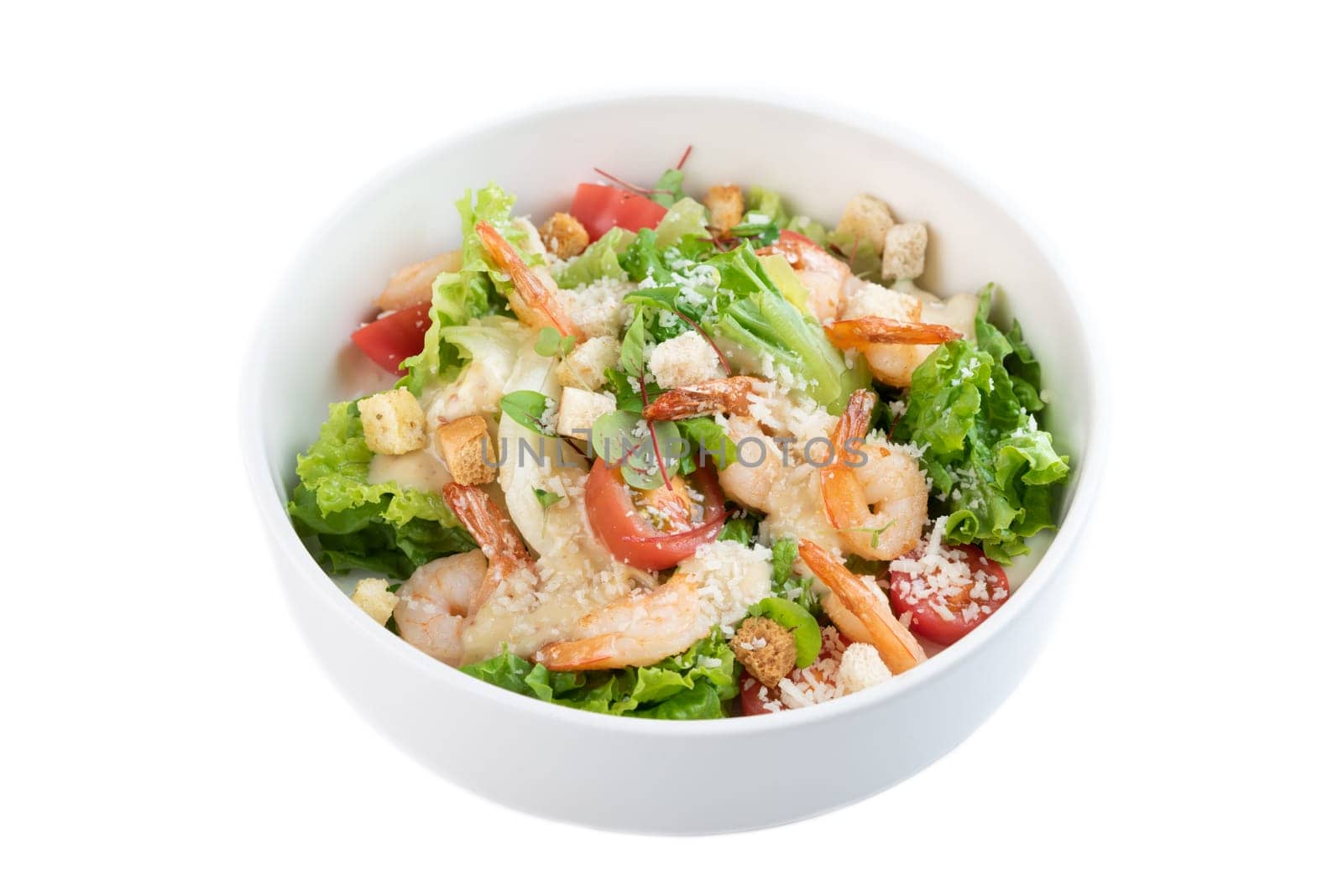 Caesar salad with shrimps on white background top view
