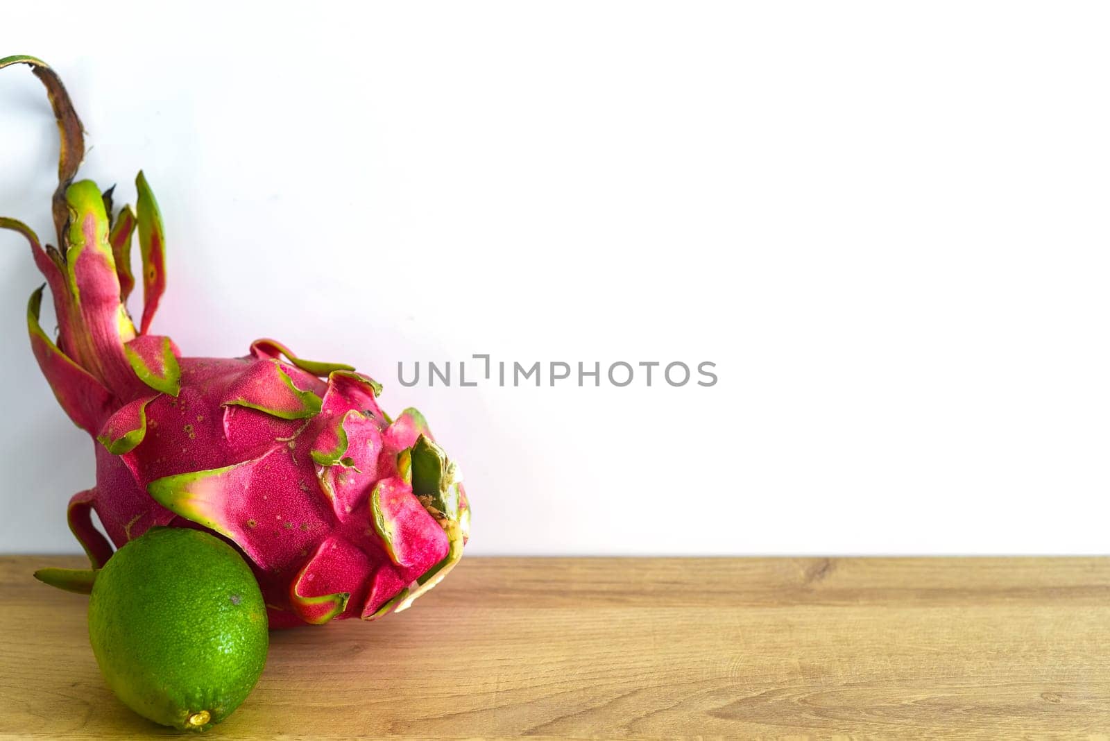 Pitaya or dragon fruit with lime on wooden table