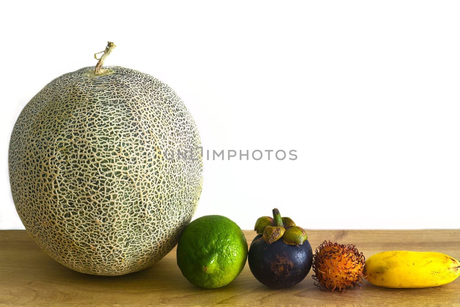 Many vietnamese fruit on wooden table against white background