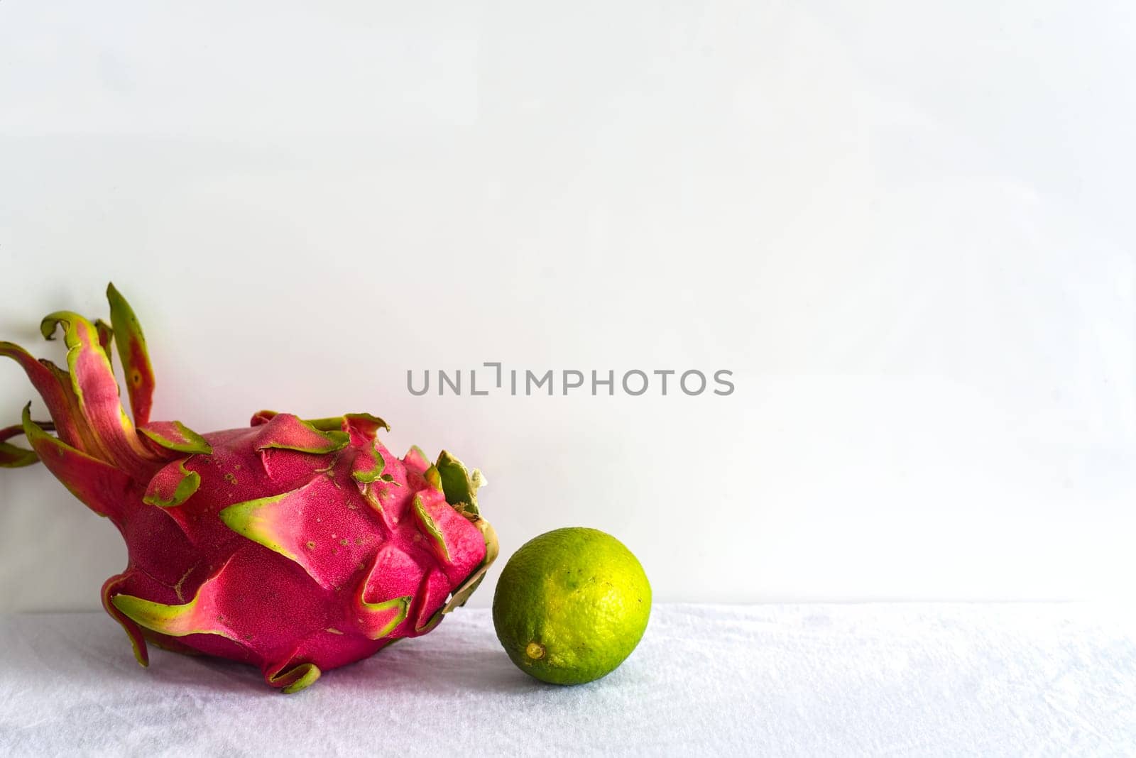 Pitaya or dragon fruit with lime on white background