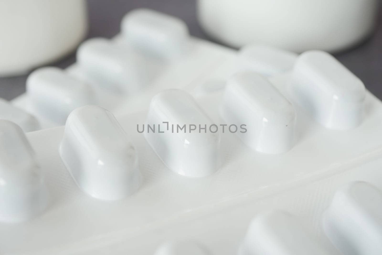 Close-up view of white pills on a surface.
