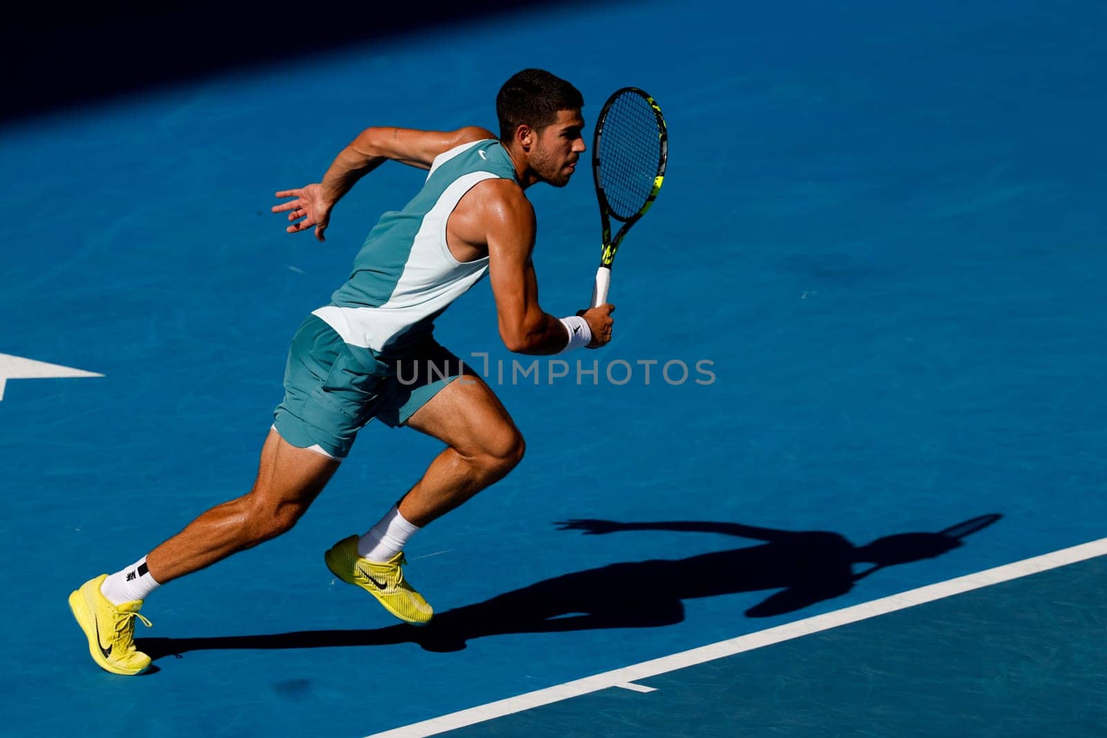 MELBOURNE, AUSTRALIA - JANUARY 19: Carlos Alcaraz of Spain runs to a ball whilst playing Jack Draper of Great Britain on day eight of the 2025 Australian Open at Melbourne Park on January 19, 2025 in Melbourne, Australia.