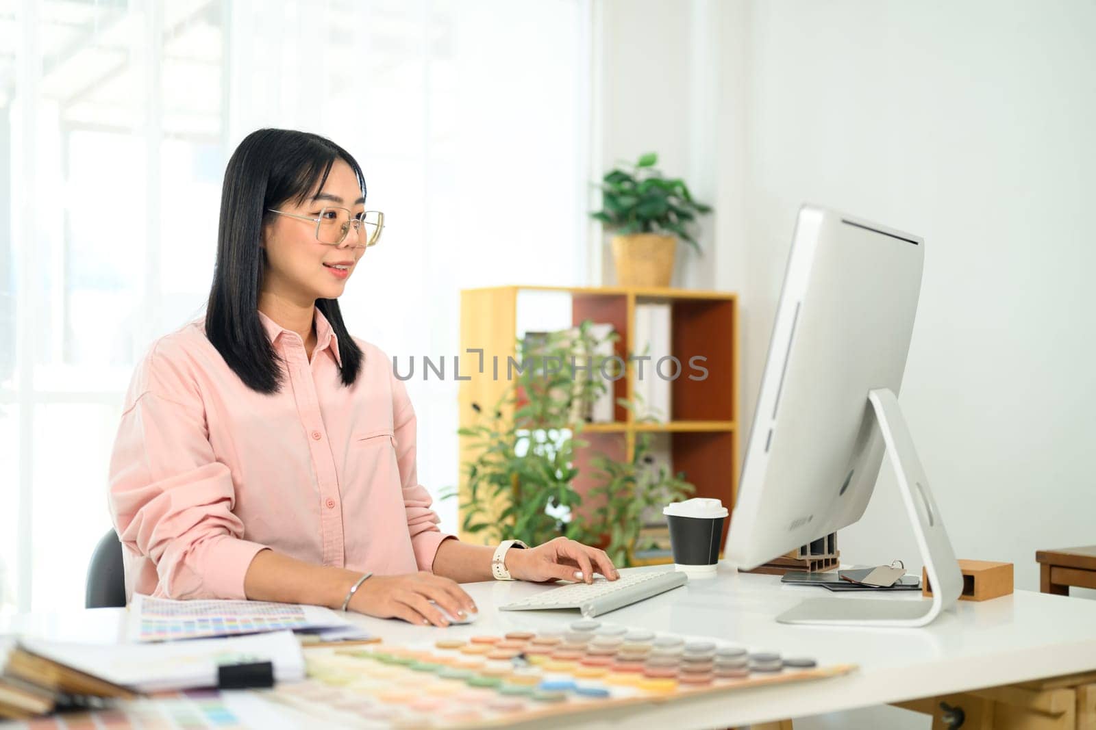 Young designer working on a new project in a bright office.