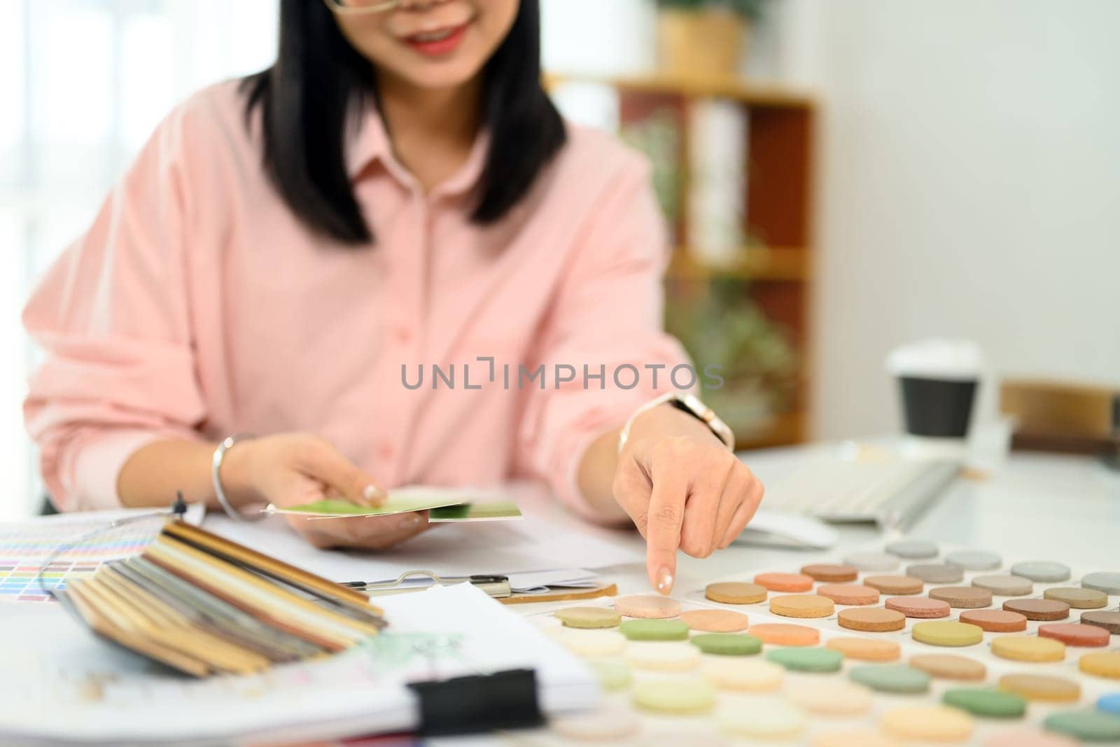 Creative interior designer working on a new project analyzing color palettes and material samples.
