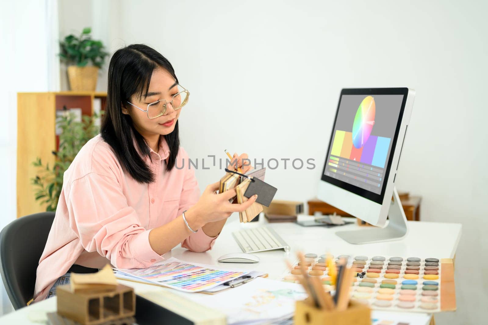 Female designer selecting colors and materials for an interior project.
