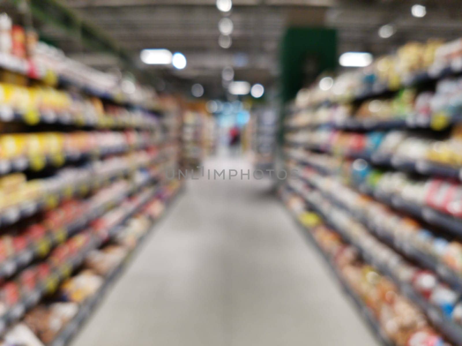 Abstract blurred supermarket aisle with colorful shelves. Blurred Background with bokeh. Copy space for text or ad design