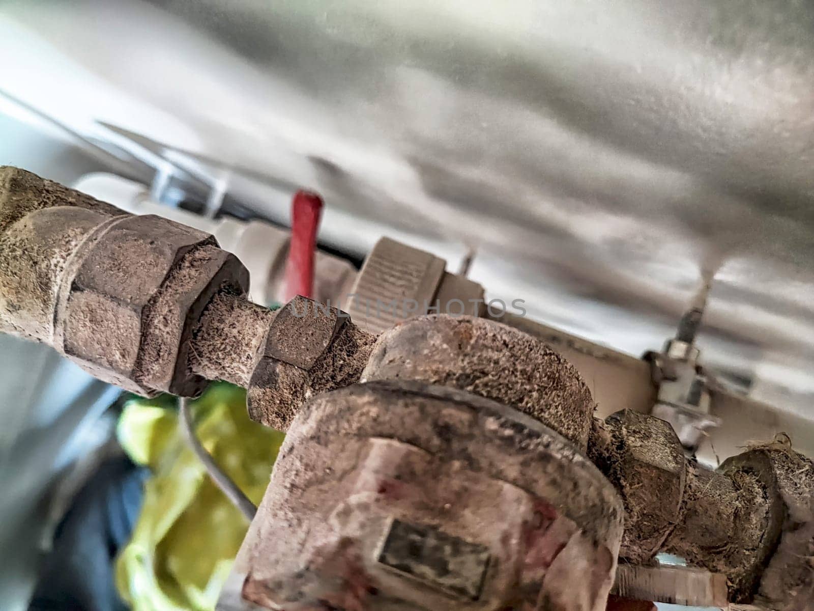 Dusty, old pipes visible in a maintenance area reflect years of wear and lack of upkeep along with potential plumbing issues.