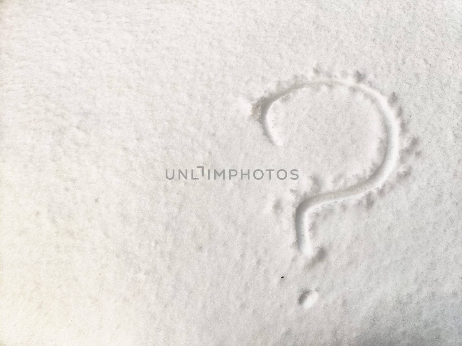 A question mark carved into a snow-covered surface raises doubts related to business matters in winter.