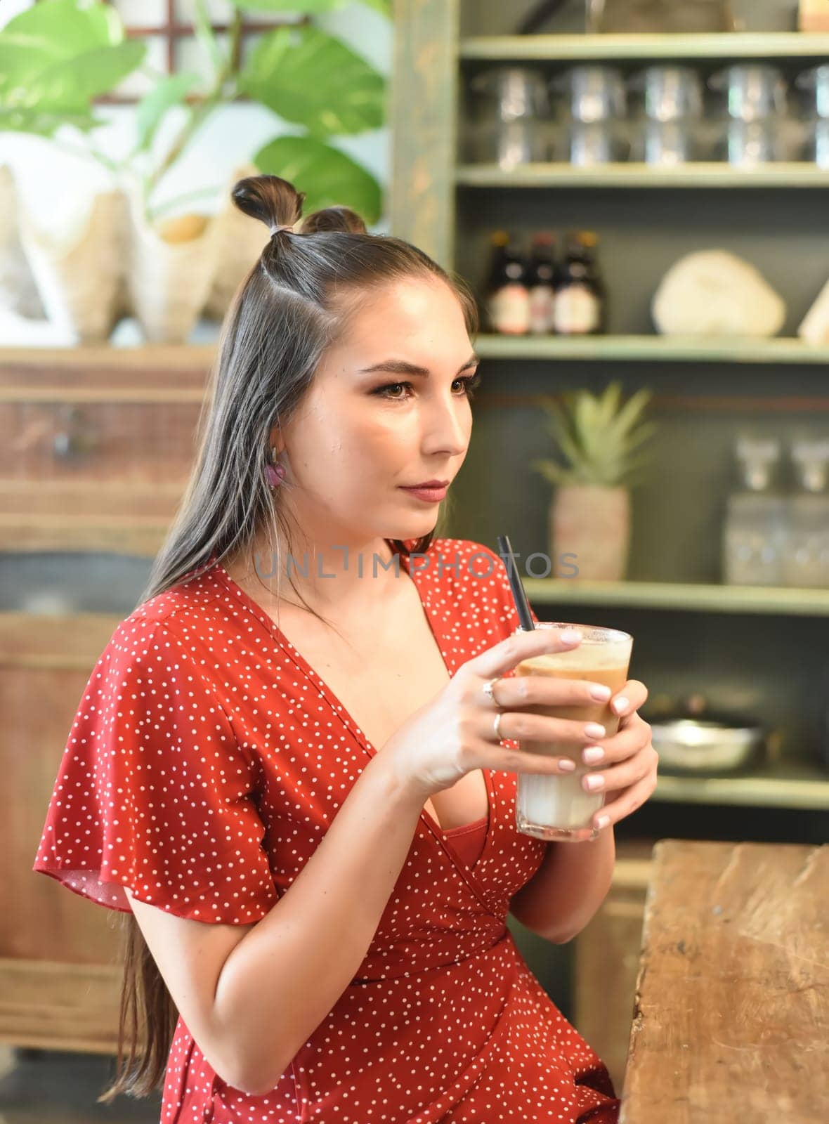 Young woman  drinking ice coffee in a coffee shop