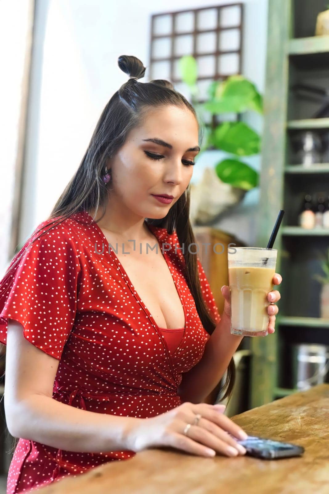 Young woman  drinking ice coffee in a coffee shop