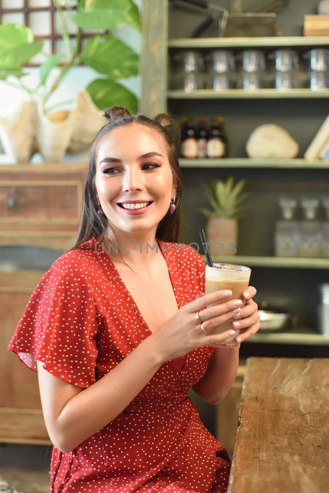 Young woman  drinking ice coffee in a coffee shop