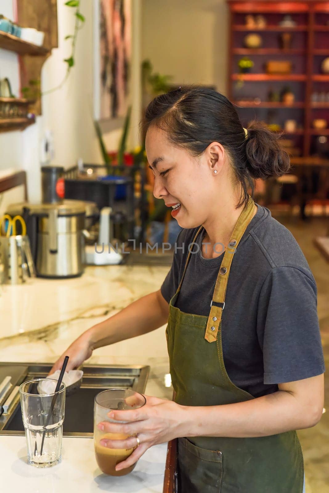 Vietnamese barista added ice and straw in vietnamese coffee Cafe SuaVietnamese barista added ice and straw in vietnamese coffee Cafe Sua
