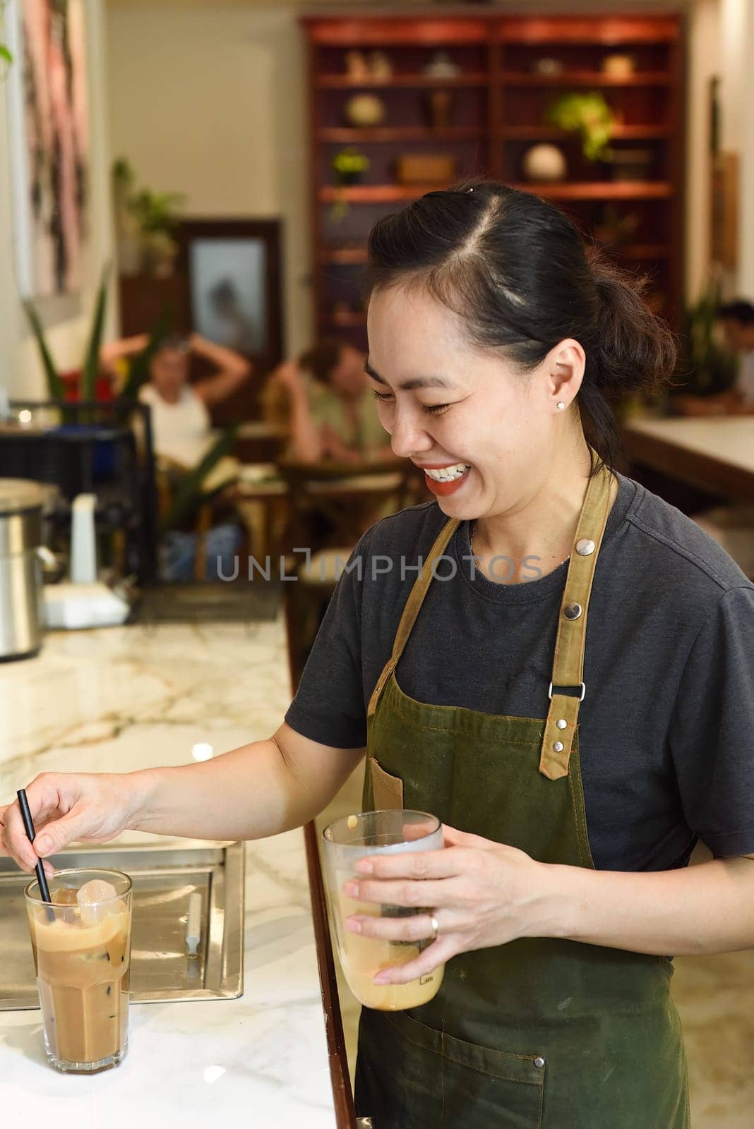 Vietnamese barista added ice and straw in vietnamese coffee Cafe SuaVietnamese barista added ice and straw in vietnamese coffee Cafe Sua
