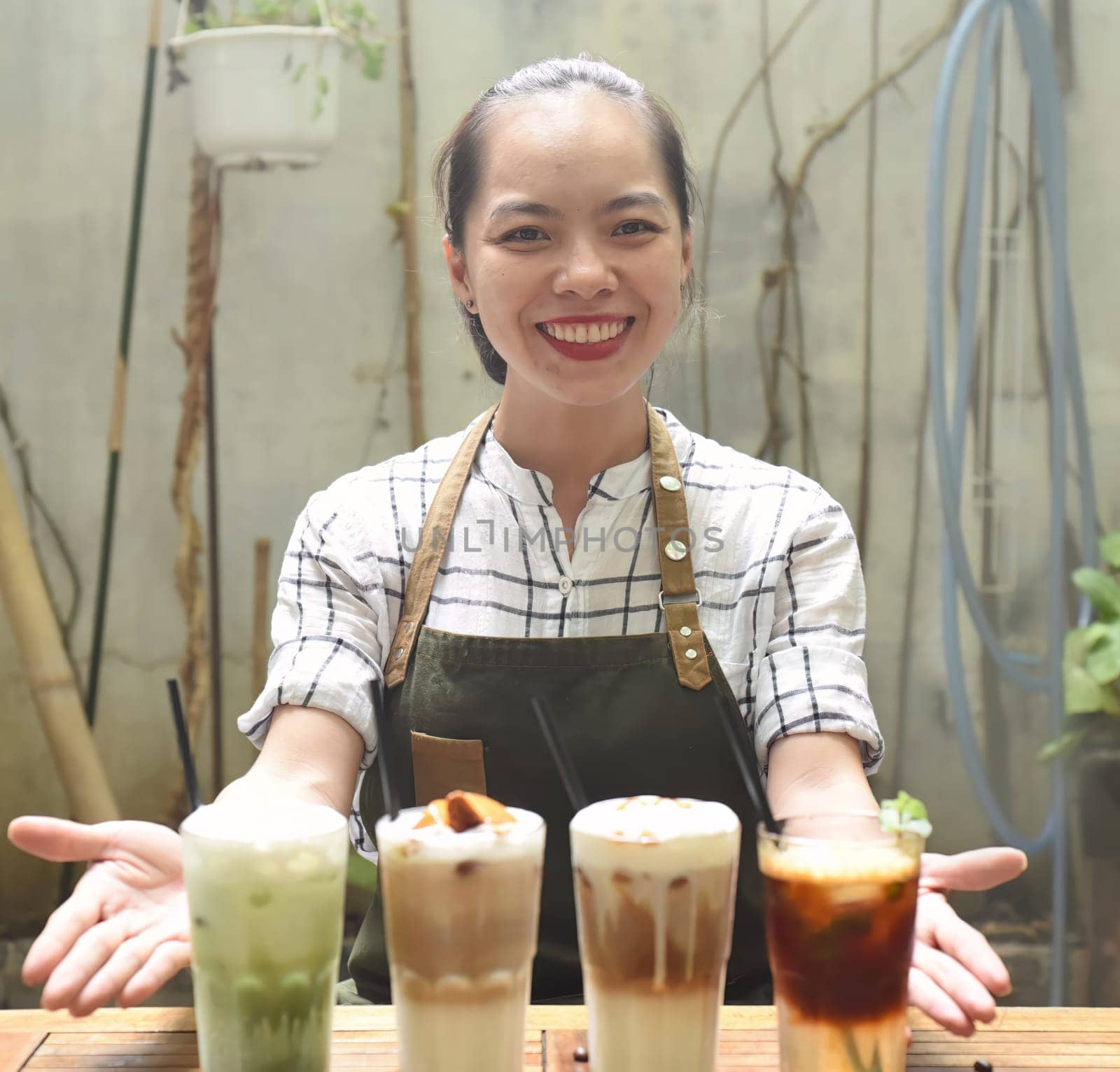 Asian woman waitress prepared beverages to serve in a coffee shop