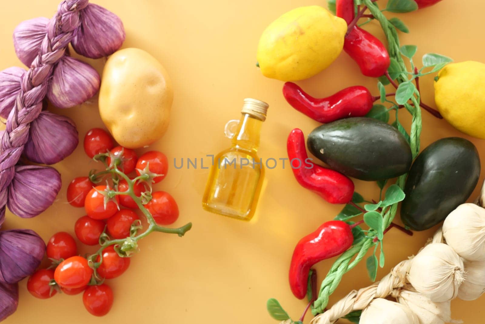 Fresh vegetables including tomatoes, peppers, and lemons with olive oil.