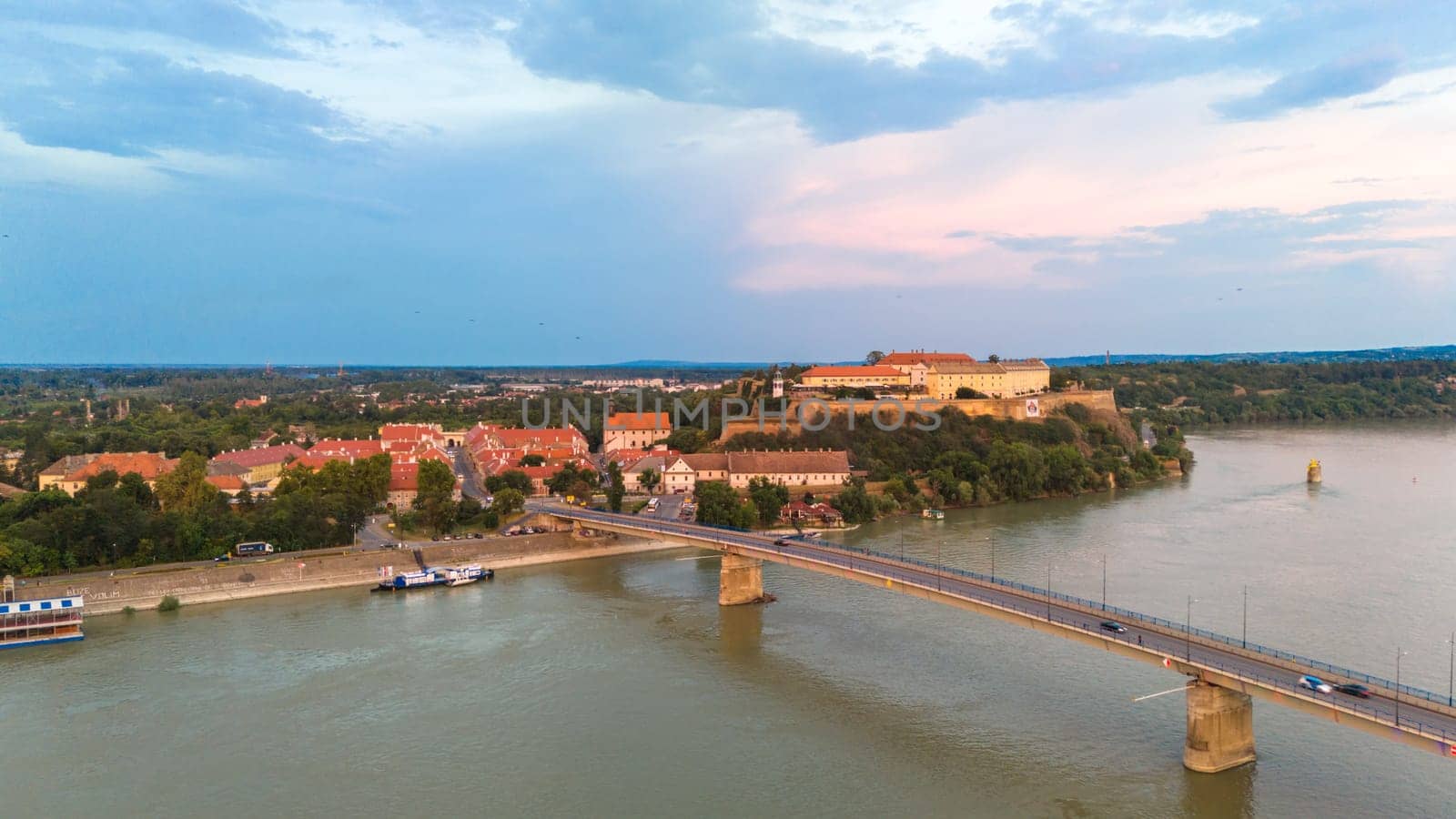 Aerial view of Petrovaradin fortress Danube river and bridge in Novi Sad Serbia during sunset