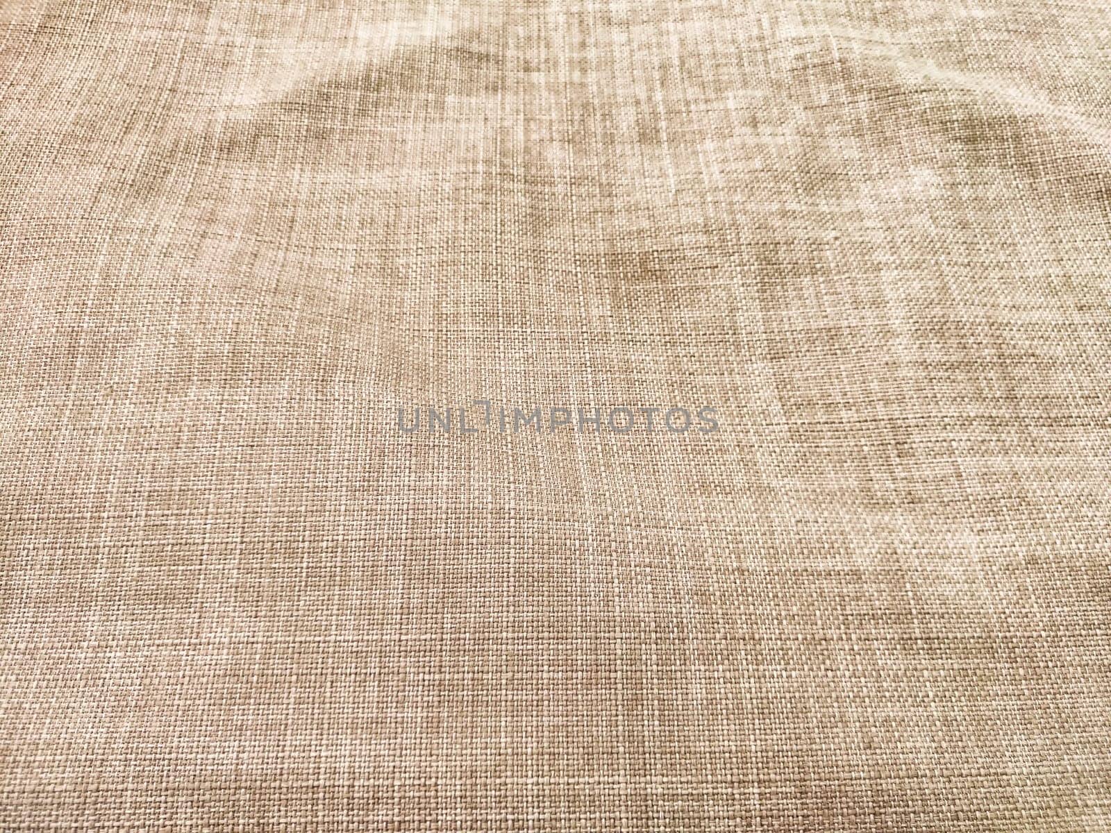 This neutral beige fabric features a subtle texture and pattern, providing an excellent backdrop for text or design elements.