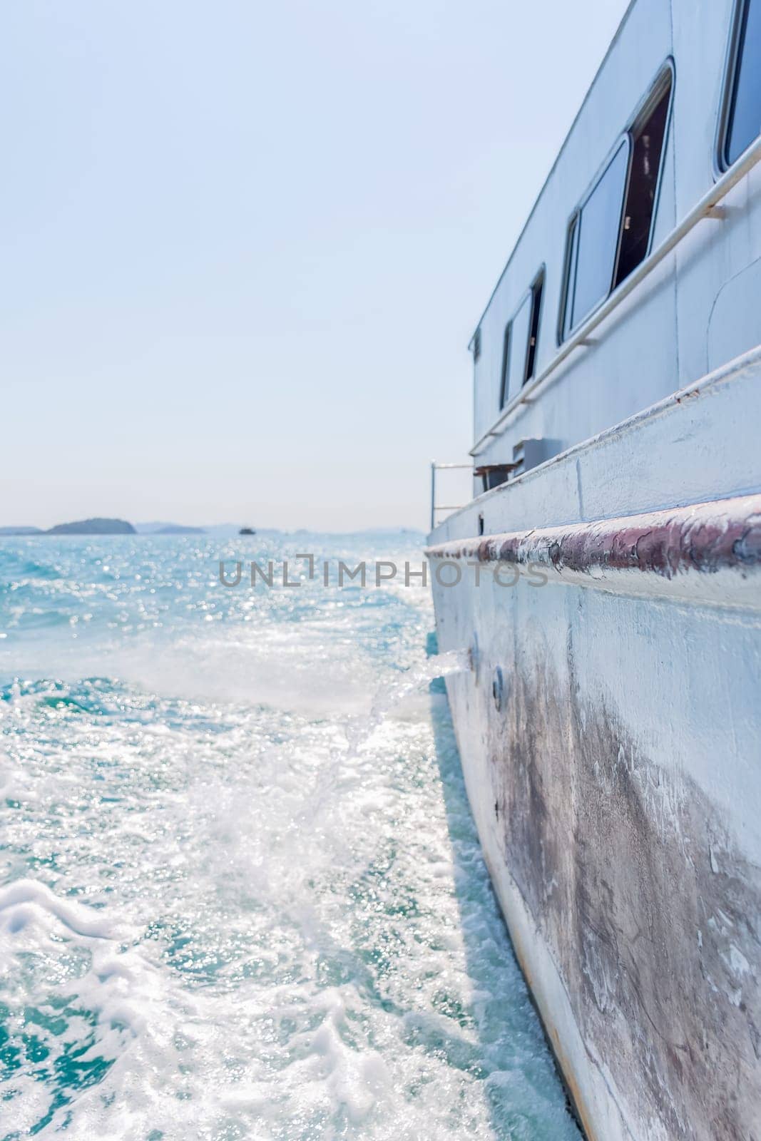 Tourist by sailing on turquoise ocean by ship with sun light in day time when vacation travel at sea for relax