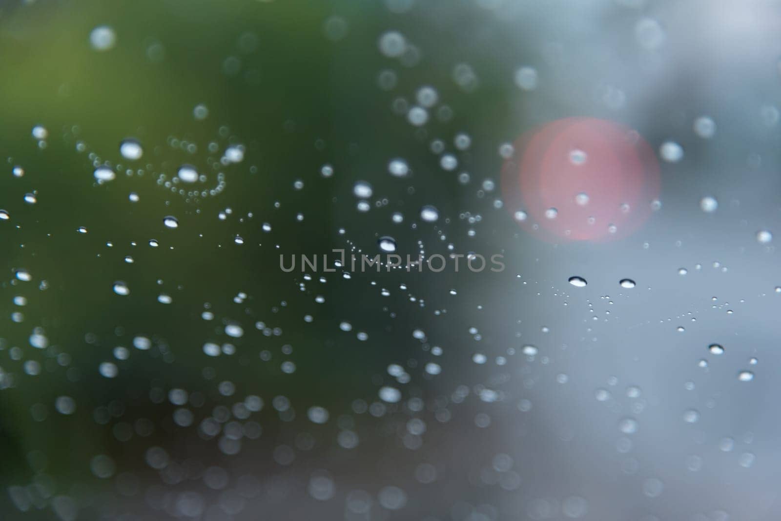 Water drops steam of rain on car windshield window glass after the rain