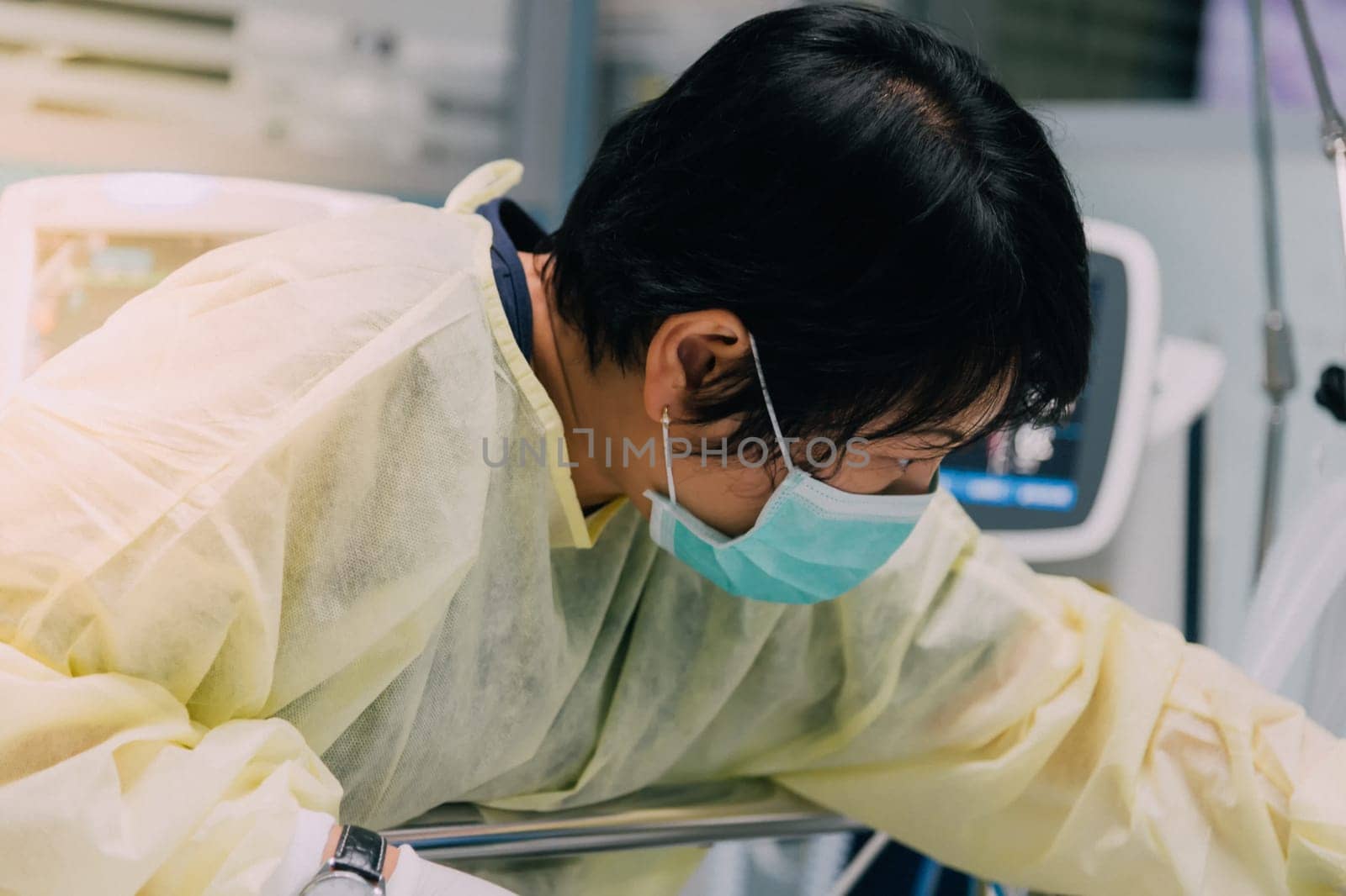 Asian women 40s years old is a patient relative taking care of the CRE. or VRE. infected elder patient 80s years old on patient bed in intensive care unit (ICU.) room at hospital.