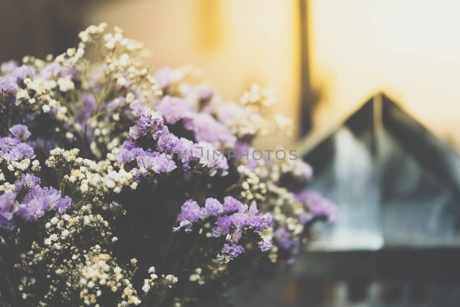 Dried flowers with statice flower in bouquet purple and yellow color use for decoration or congrats with lights bokeh background in flower shop