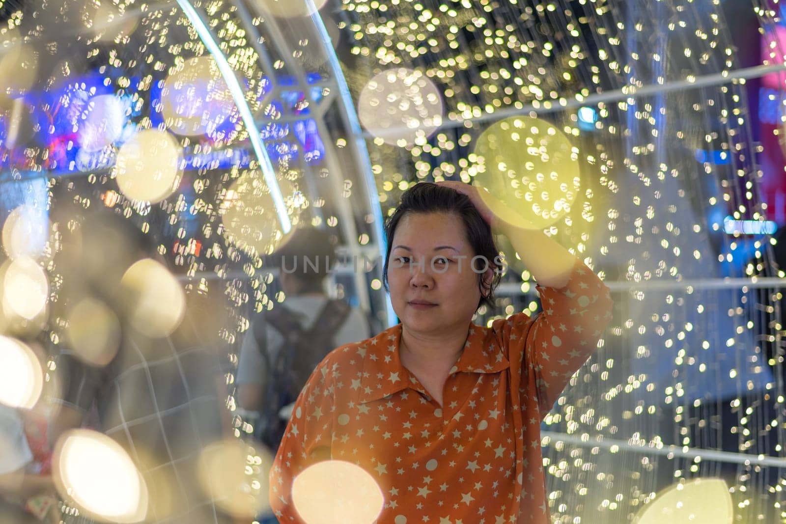 Asian woman 40s plump body fashion happy for relax in night time with bokeh of light decoration for happy new year celebration