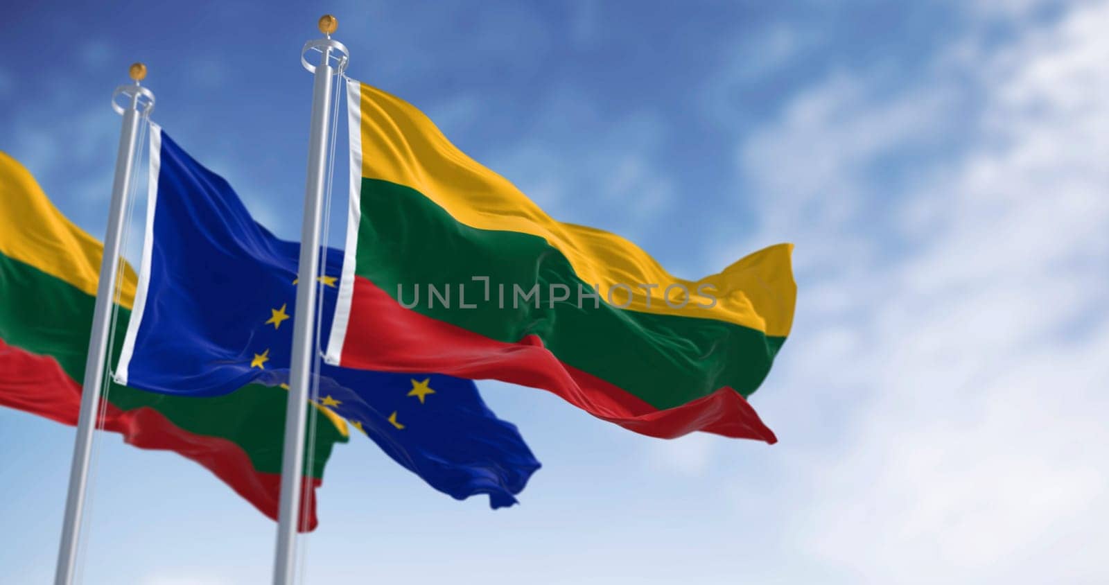 Flags of Lithuania and the European Union waving together on a clear day. Lithuania became a member of the European Union on 2004. 3D illustration render. Rippled fabric. Selective focus