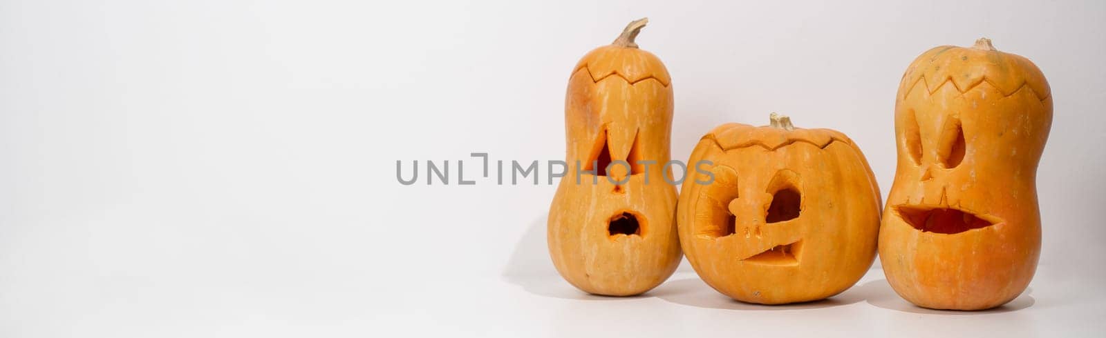 Three jack-o-lantern on a white background. Halloween decoration. Widescreen. by mrwed54