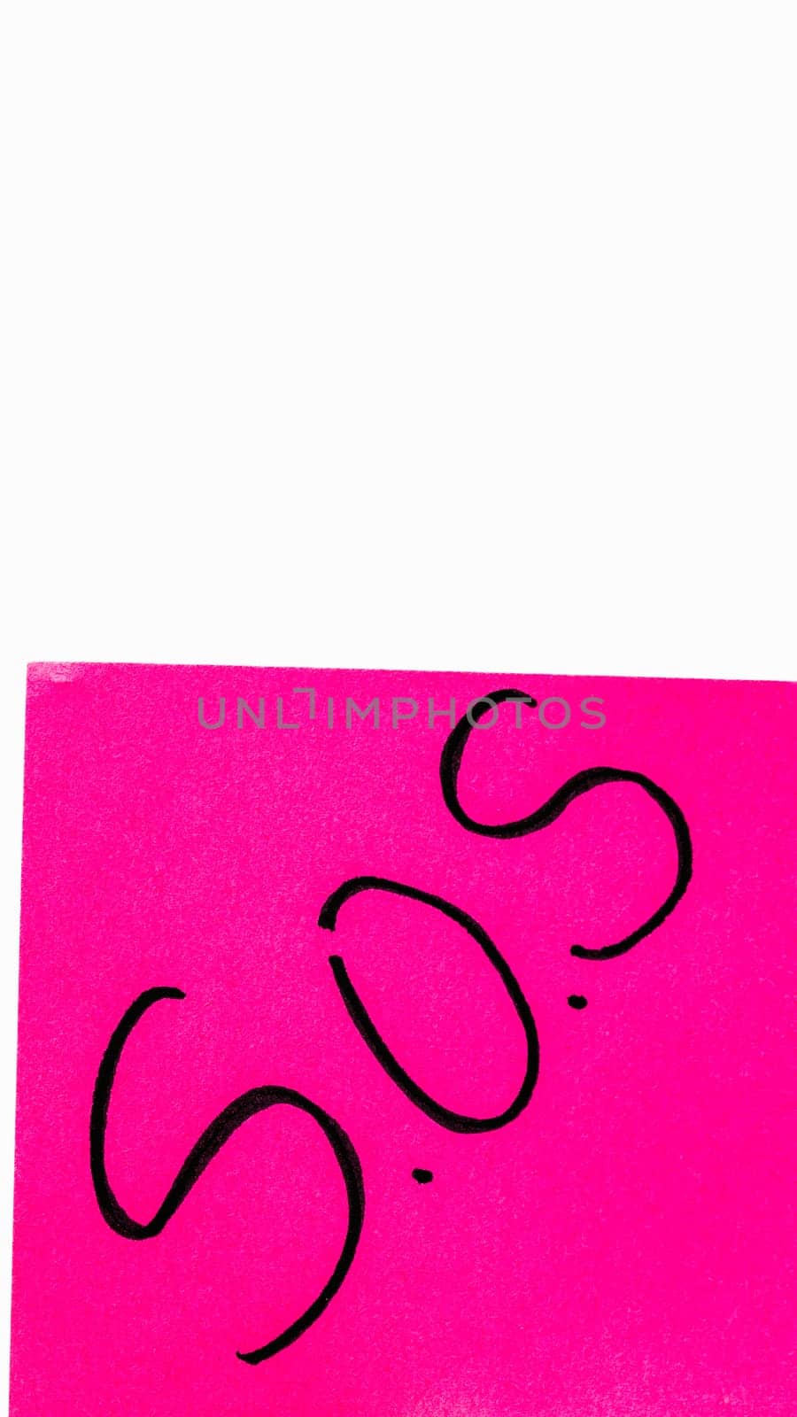 SOS handwriting text close up isolated on pink paper with copy space. Writing text on memo post reminder  by vladispas