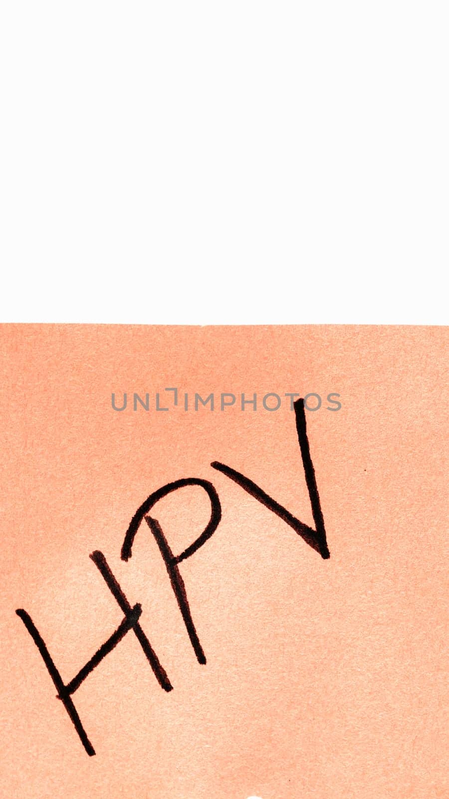 HPV handwriting text close up isolated on orange paper with copy space. Writing text on memo post reminder