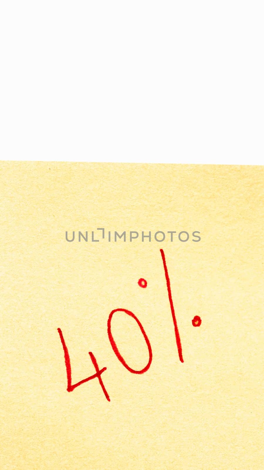 40% handwriting text close up isolated on orange paper with copy space. Writing text on memo post reminder. by vladispas