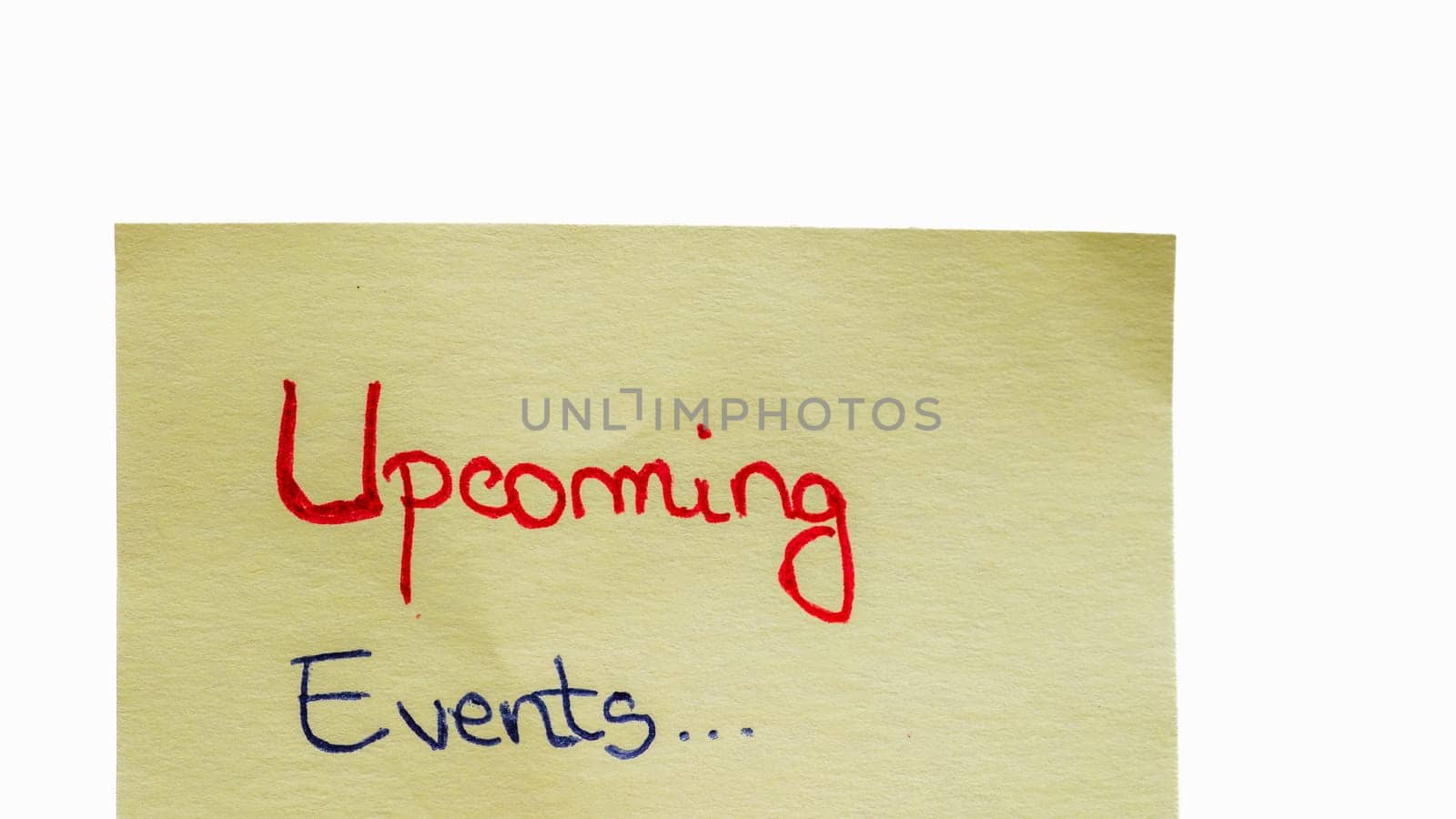 Upcoming events handwriting text close up isolated on yellow paper with copy space.