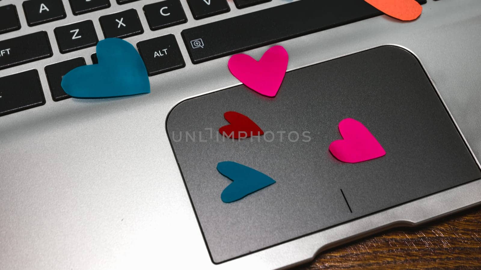 Heart shaped paper cut out on keyboard, love message and Valentine`s day concept. by vladispas
