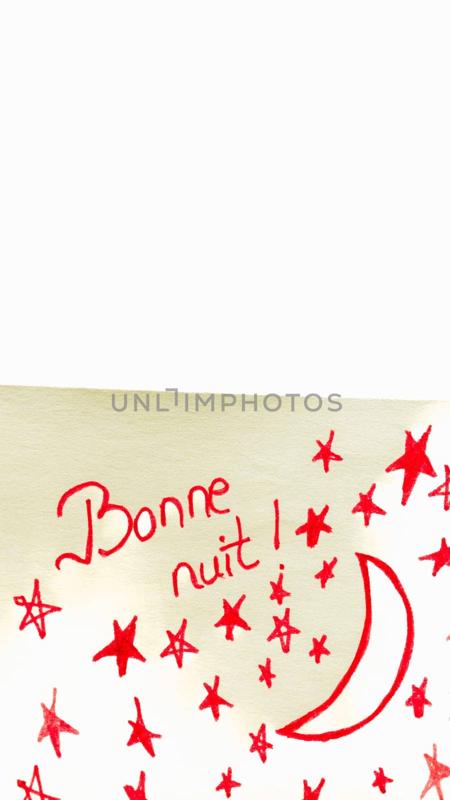 Bonne nuit (good night) handwriting text close up isolated on yellow paper with copy space.