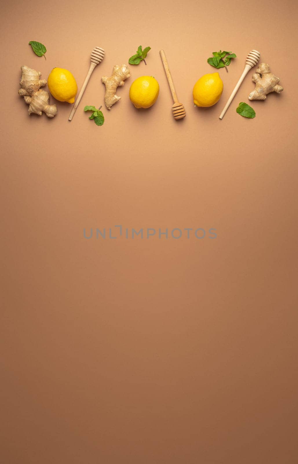 Composition with lemons, mint, ginger top view on simple beige background. Food for immunity stimulation and against seasonal flu. Healthy natural remedies to boost immune system.
