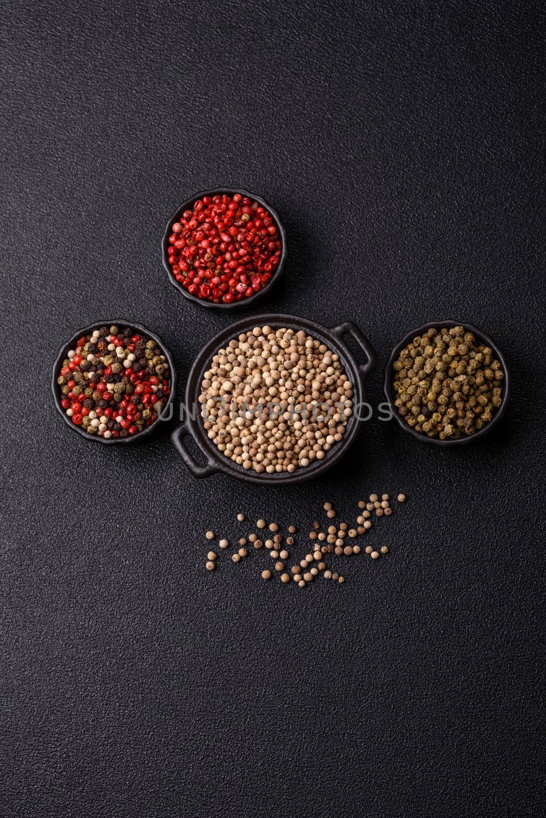 White allspice in a ceramic bowl on a dark concrete background