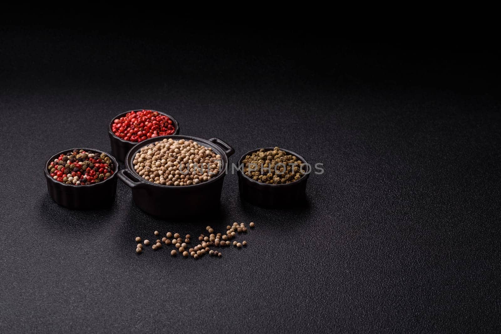White allspice in a ceramic bowl on a dark concrete background