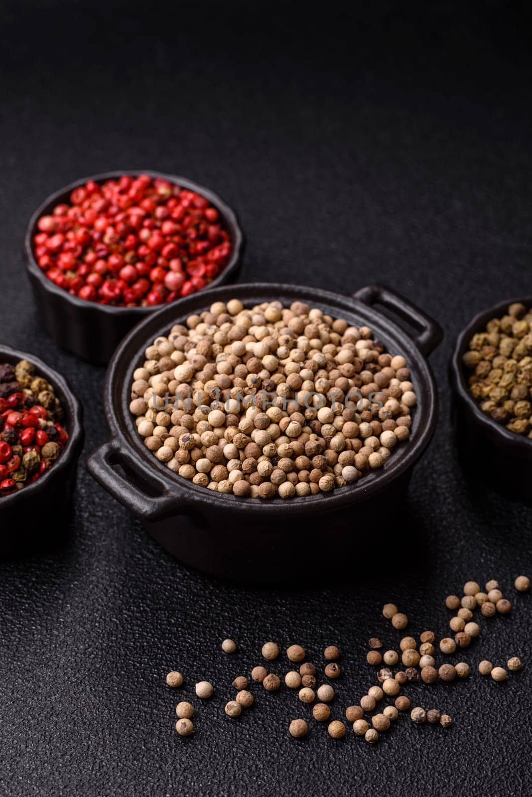 White allspice in a ceramic bowl on a dark concrete background