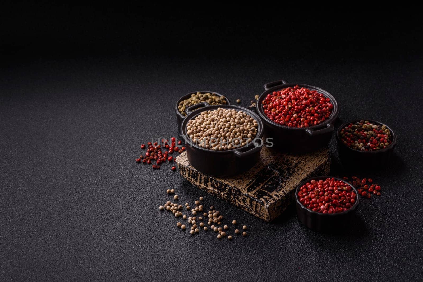 White allspice in a ceramic bowl on a dark concrete background