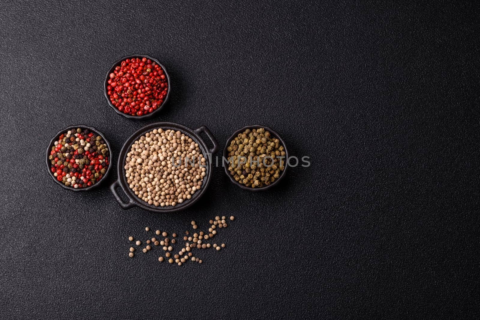 White allspice in a ceramic bowl on a dark concrete background