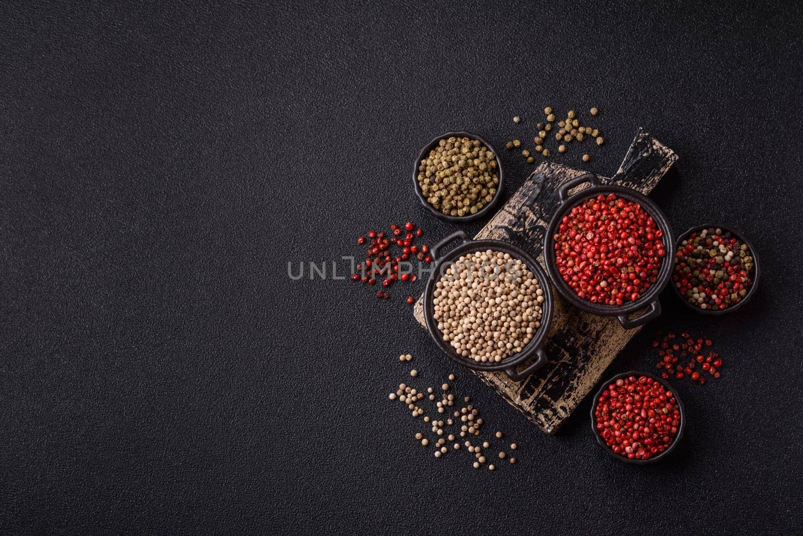 White allspice in a ceramic bowl on a dark concrete background
