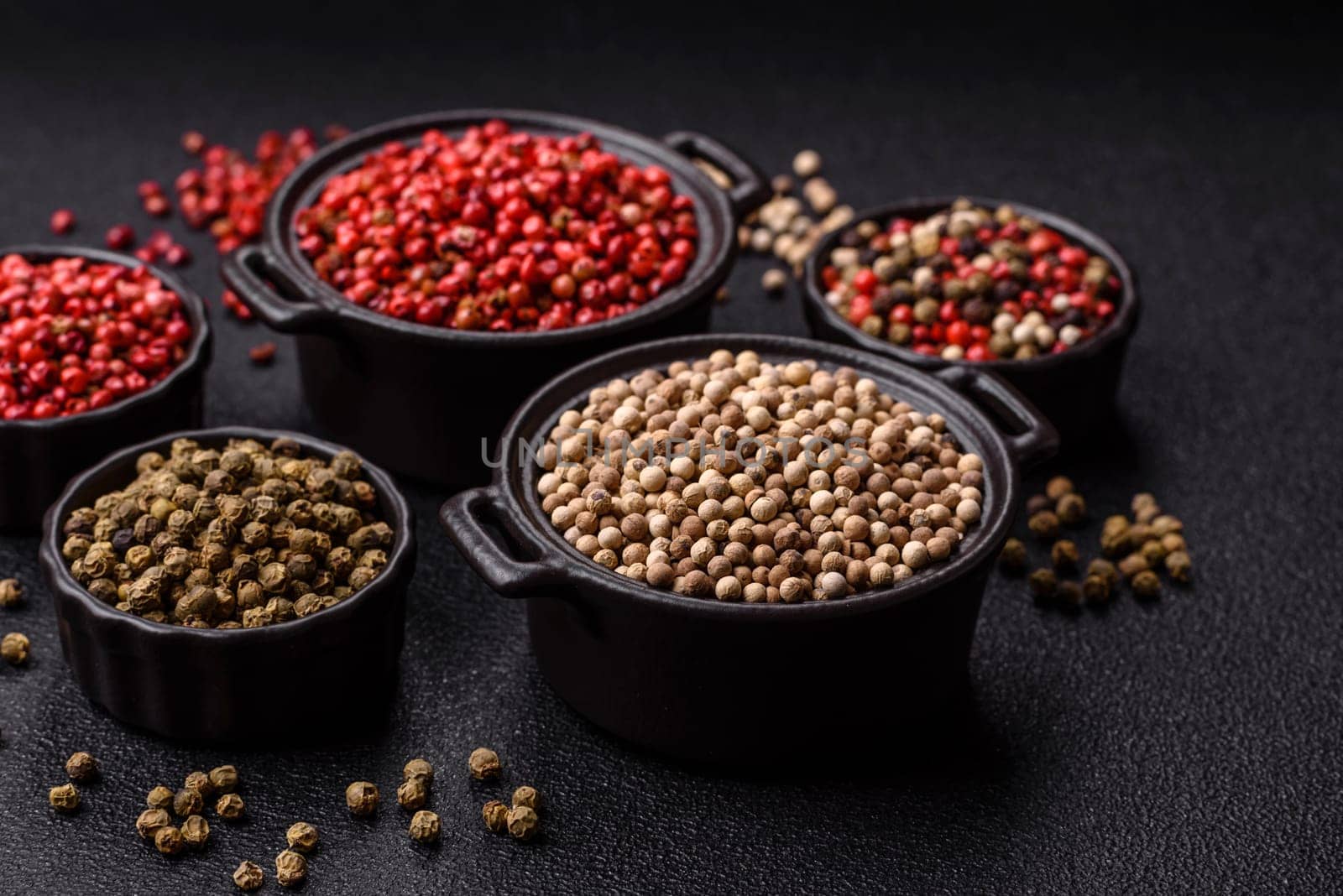 White allspice in a ceramic bowl on a dark concrete background