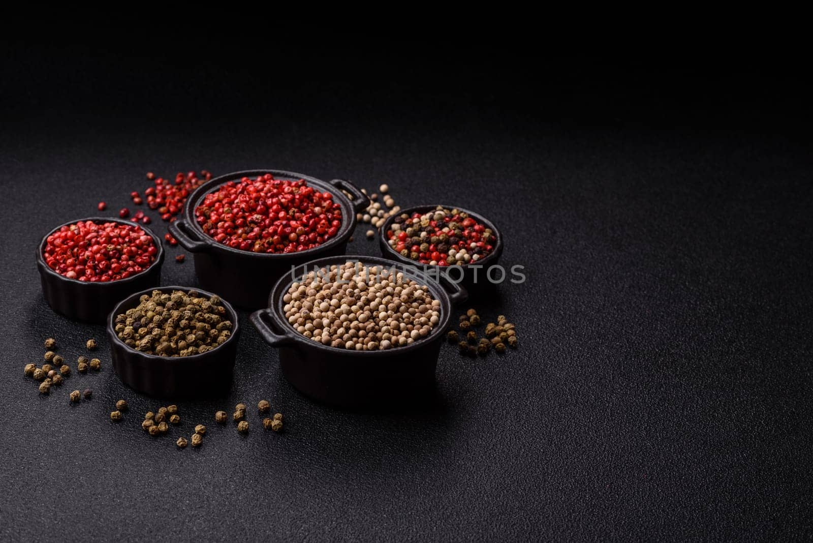 White allspice in a ceramic bowl on a dark concrete background