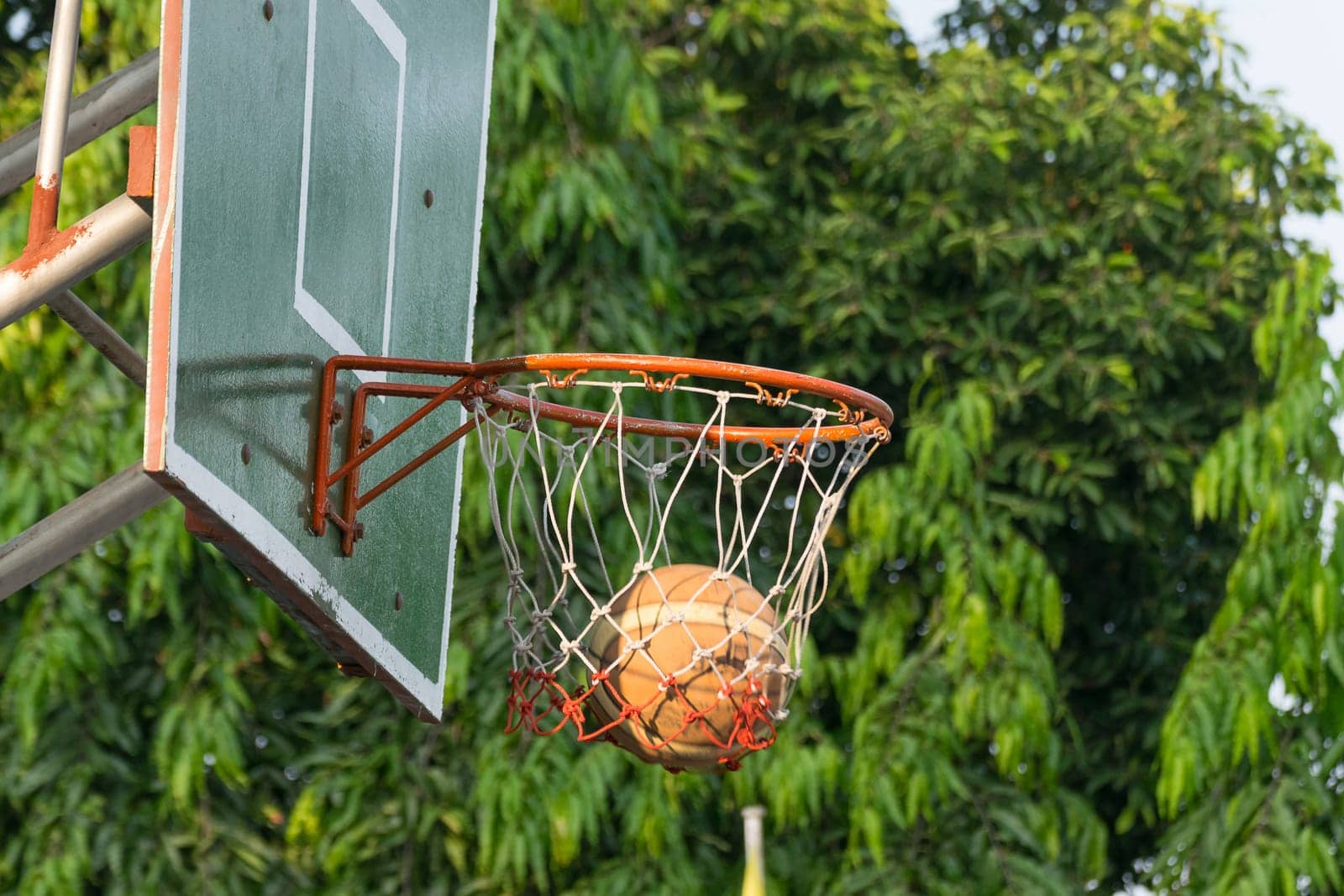 Basketball hoop make by wooden and ball in park